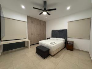 a bedroom with a bed and a ceiling fan at Hotel Suites Reyvaj in Mérida +16 photos