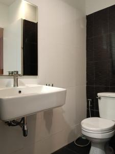 a bathroom with a white sink and a toilet at Rabbit Room in Bangkok +10 photos