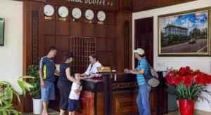 a group of people standing in front of a counter at Sunrise Hotel in Dong Hoi