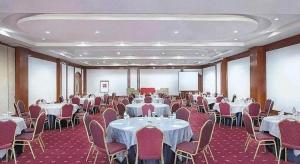 a banquet hall with tables and chairs at Hotel Horison Arcadia Heritage Surabaya in Surabaya +248 photos