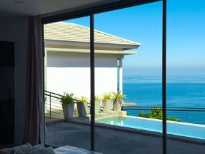 a view of the ocean from the balcony of a house at Staylar Seaview Pool Villa Gina Chaweng Noi in Bophut 