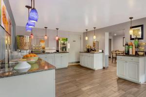 a large kitchen with white cabinets and a counter at Quality Inn & Suites Easley - Greenville in Easley