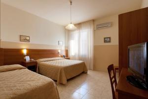 Postel nebo postele na pokoji v ubytování Parking Hotel Giardino