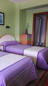 Postel nebo postele na pokoji v ubytování Hostal J.B