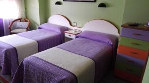 Postel nebo postele na pokoji v ubytování Hostal J.B