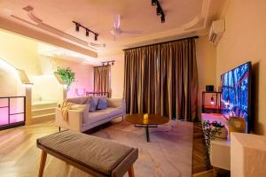 a living room with a couch and a tv at Tere Home Landed Stylish&Warm Flamingo Pinky House in Shah Alam