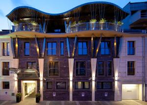 an apartment building with a balcony on top of it at Niebieski Art Hotel & Spa in Krakow