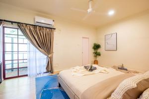 a bedroom with a large bed and a window at Tere Home Landed Stylish&Warm Flamingo Pinky House in Shah Alam