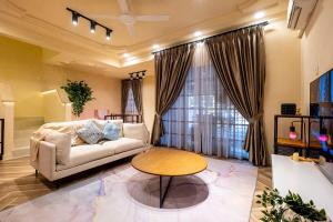 a living room with a couch and a table at Tere Home Landed Stylish&Warm Flamingo Pinky House in Shah Alam +56 photos