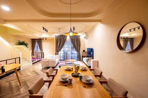 a dining room with a table and a living room at Tere Home Landed Stylish&Warm Flamingo Pinky House in Shah Alam