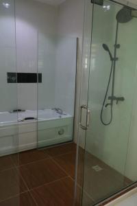 a bathroom with a shower and a bath tub at Luxury 4 bedroom fully detached duplex in Lekki