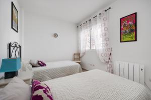 a bedroom with two beds and a window at CB Living - Apartment with roof terrace Aguamarina in Orihuela Costa