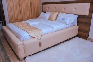 Havana Cottages-Hyrax Deluxe Master في ناكورو: سرير أبيض كبير في الغرفة