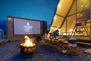 a stage with a fire pit in front of a screen at 가평 스페인마을 풀램핑 Spanish Village Poolamping in Hwarangp'o