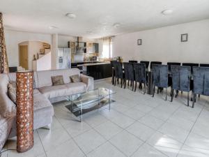 a living room with a couch and chairs and a table at Cosy holiday home in Tuscany with shared swimming pool in San Casciano in Val di Pesa