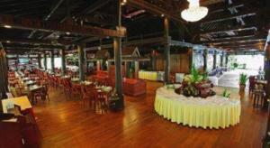 a large room with tables and chairs in a building at Sokhalay Angkor Residence and Spa in Siem Reap