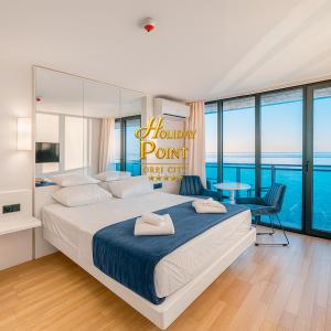 Ένα ή περισσότερα κρεβάτια σε δωμάτιο στο Holiday Point Orbi City