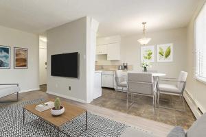 a living room with a kitchen and a dining room at Mdx in Edmonton