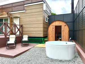 a bath tub sitting on a deck next to a building at Solana富士御殿場 in Gotemba +84 photos