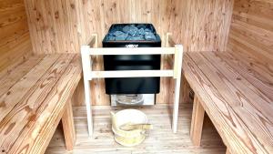 a room with a stove in a wooden room at Solana富士御殿場 in Gotemba