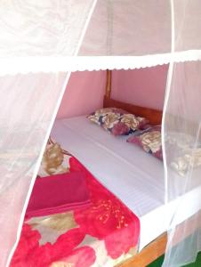 Ένα ή περισσότερα κρεβάτια σε δωμάτιο στο kapi wild cottage Ella