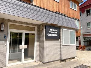 a building with a sign on the front of it at Yuzawa Toyo - Vacation STAY 98053 in Yuzawa