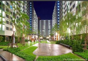 a walkway in a city at night with tall buildings at Lumpini nawamin in Ban Bang Toei (1)
