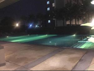 an empty swimming pool at night with green lights at Lumpini nawamin in Ban Bang Toei (1)