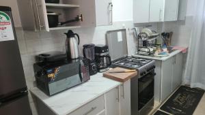 a small kitchen with a stove and a microwave at Naivasha Naivegas C5 Staycation by Charlie izzy in Munyu +10 photos