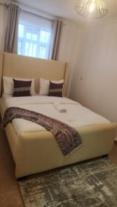 a large bed in a bedroom with a window at Naivasha Naivegas C5 Staycation by Charlie izzy in Munyu