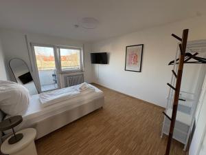 Altstadtperle Ettlingen mit Smart TV und WLAN في إيتلينغن: غرفة نوم بها سرير ونافذة كبيرة