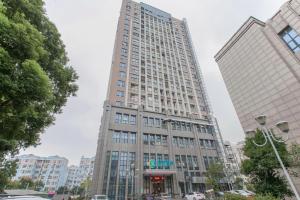 a tall building in the middle of a city at City Comfort Inn Wuhan Rui'an Street Metro Station in Wuhan