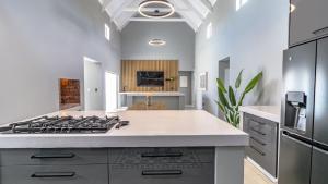 a kitchen with a stove and a counter top at Skobbejak in Paternoster