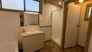 a bathroom with a sink and a shower at Wonderland Cottages in Halls Gap +80 photos