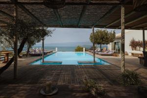 a swimming pool with a view of the ocean at The Villa Amalia in Spartos