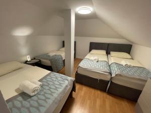 two beds in a small room with at Hotel Pohorje in Maribor +70 photos