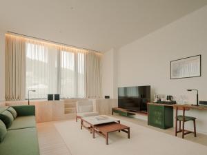 a living room with a couch and a table at The Telegraph Hotel - The Leading Hotels of the World in Tbilisi City