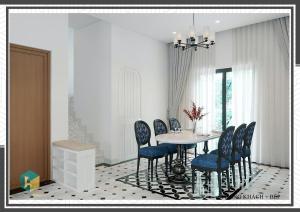 a dining room with a table and blue chairs at Villa Malibu Tropicana , Nova Hồ Tràm in Ấp Thanh Bình