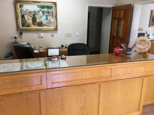 a large wooden reception desk in an office at Garden Inn and Suites Fresno in Fresno