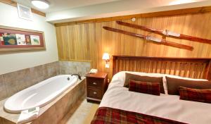 
a hotel room with a bed, toilet and bathtub at Embarc Panorama by Diamond Resorts in Panorama
