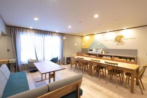 a living room with a table and chairs at B cycle ダブルルーム in Biei