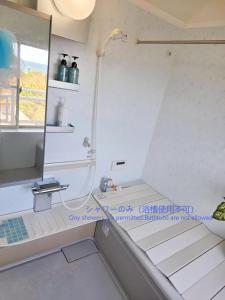 a bathroom with a shower with a sink and a mirror at パーティーができるビーチハウス海まで1分一棟貸切Qiao105屋外犬可 in Hokota +45 photos