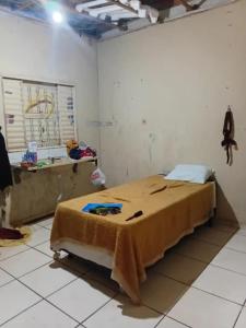 een slaapkamer met een bed met een deken erop bij Kika low on in Caldas Novas