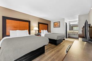 Ένα ή περισσότερα κρεβάτια σε δωμάτιο στο Quality Inn +46 φωτογραφίες