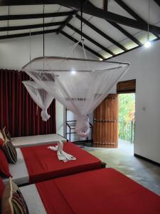 a bedroom with two beds and a chandelier at Nice View Safari villa in Udawalawe +76 photos
