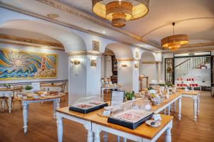 a restaurant with tables with food on them at Hotel Villa Frigiliana in Frigiliana