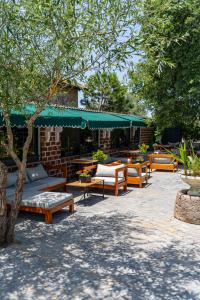 a patio with a bunch of benches and tables at simlarda aquapark otel in Ayvalık