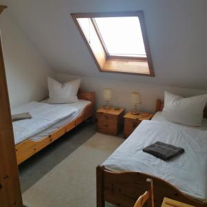 a bedroom with two beds and a skylight at Hotel mit Gasthof zur Post in Hochkirch +11 photos