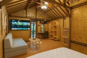 a room with a bed and a couch and a tv at Casa de Monique Glamping Resort in Bogor +155 photos
