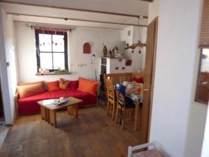 un soggiorno con un divano rosso e un tavolo di Ferienhof Haus Sulztal a Berching
